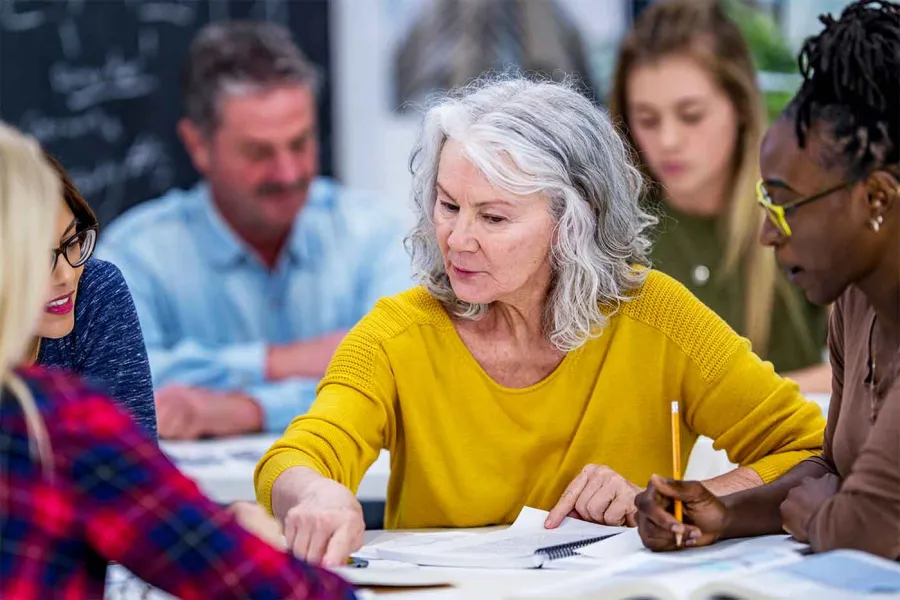 A group of educators collaborate on a team project